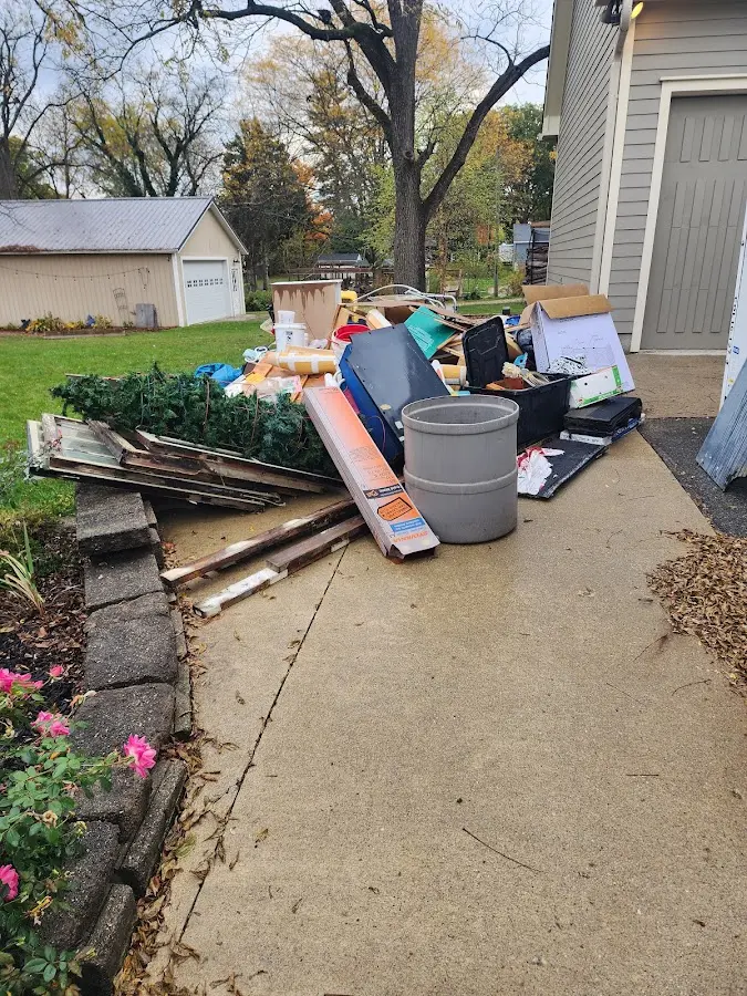 Dumpster being loaded with debris for Estate Cleanout Dumpster Rental in Richardson